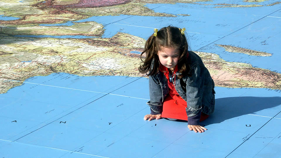 girl exploring a huge world map